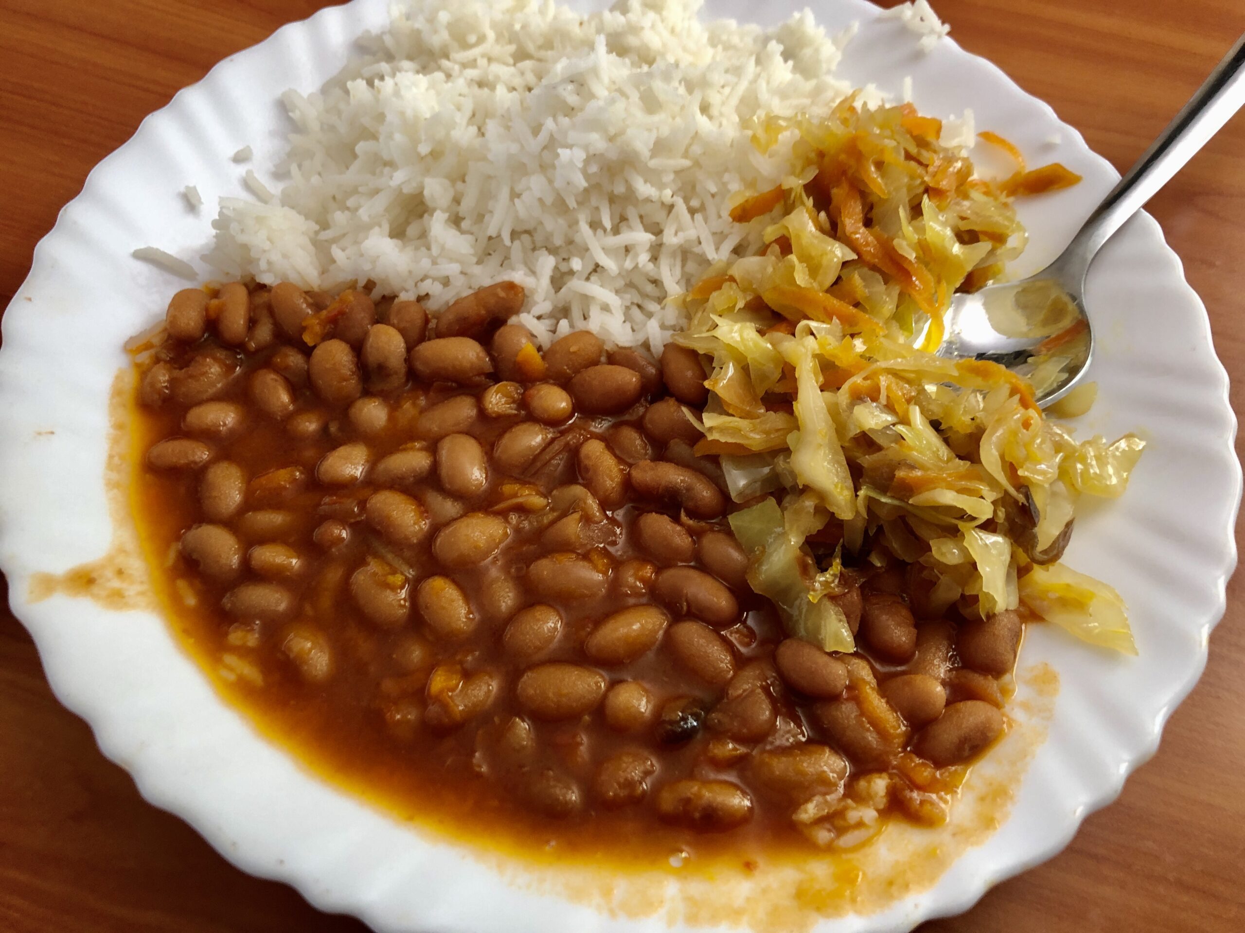 A plate of rice, beans and cabbage